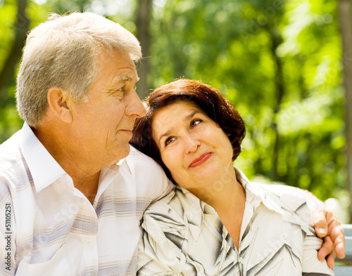 Photo: Senior happy couple embracing, outdoors Senior happy couple embracing, outdoors