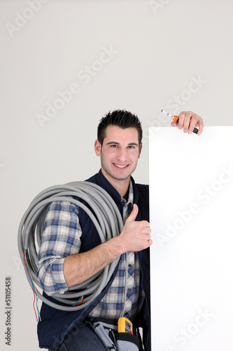 Photo: Thumbs up from an electrician with a blank board Thumbs up from an electrician with a blank board