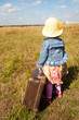 lonely girl with suitcase. Back view