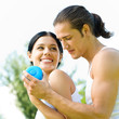 Cheerful couple with dumbbells on workout