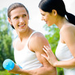 Cheerful couple with dumbbells on workout