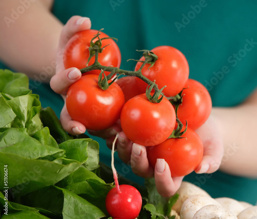 Photo: Woman holding fresh tomatoes Woman holding fresh tomatoes