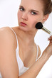 Woman with a blusher brush
