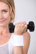 Photo: Closeup of woman with dumbbell Closeup of woman with dumbbell