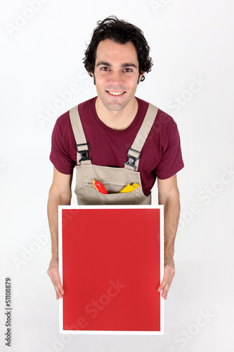 Photo: Carpenter with a blank board Carpenter with a blank board