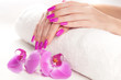 beautiful manicure with pink orchid and towel