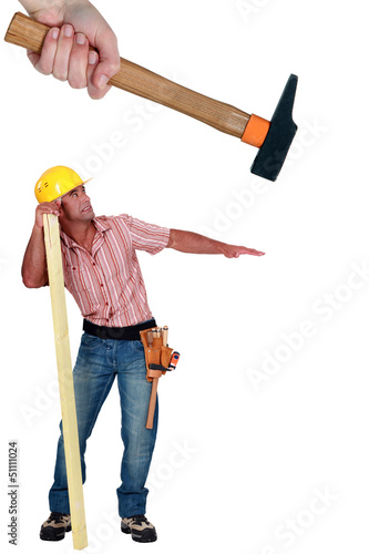 Photo: Construction worker being hit with a hammer Construction worker being hit with a hammer