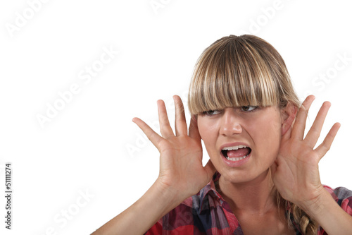 Photo: Young woman struggling to hear Young woman struggling to hear