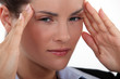 A businesswoman having a headache.