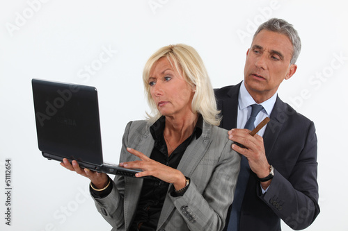 Photo: business people analyzing information on their laptop business people analyzing information on their laptop
