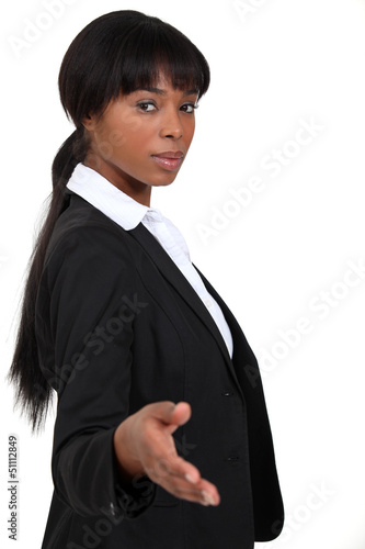 Photo: Businesswoman holding out hand Businesswoman holding out hand