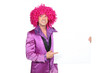 Man in silly seventies costume holding board for message