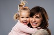Happy smiling young mother hugs her  daughter