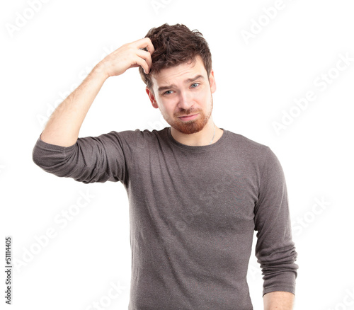 Photo: Portrait of Young Man Looking Perplexed Portrait of Young Man Looking Perplexed