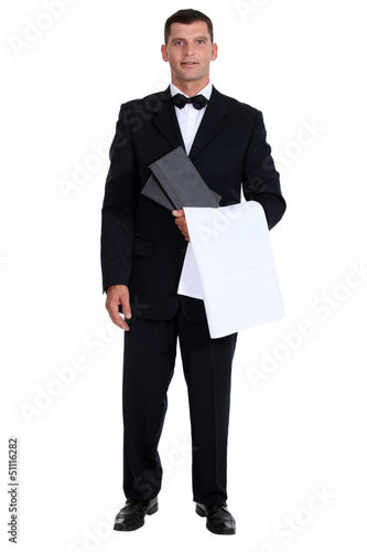 Photo: Male waiter stood holding menu Male waiter stood holding menu