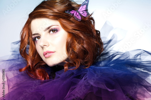 Photo: pretty woman with a butterfly in her hair - beauty shot pretty woman with a butterfly in her hair - beauty shot