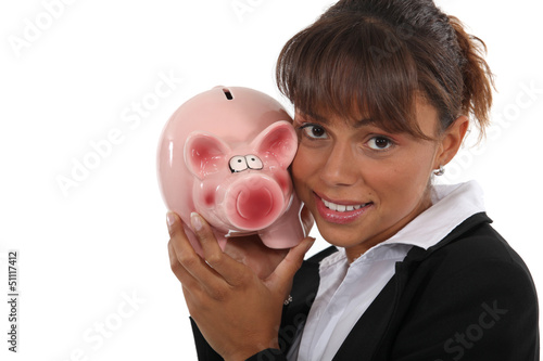 Photo: Woman with a piggy bank in hand Woman with a piggy bank in hand