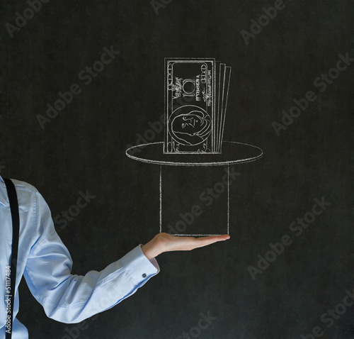 Photo: Man pulling money from magic hat blackboard background Man pulling money from magic hat blackboard background
