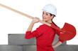 Female construction worker with a shovel