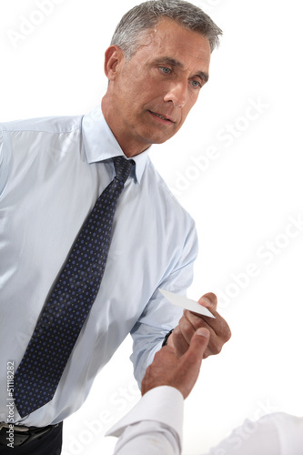Photo: Businessman handing out business card Businessman handing out business card