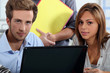 Interns sitting at a desk with computer