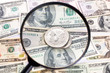 Foto: Silver dollar coin under magnifying glass Silver dollar coin under magnifying glass