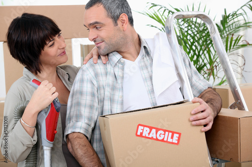 Photo: Couple moving into new home Couple moving into new home