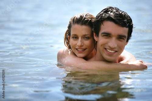 Photo: couple embracing in the water couple embracing in the water