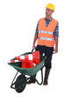 Man with wheelbarrow full of traffic cones