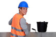 Young mason happily working away