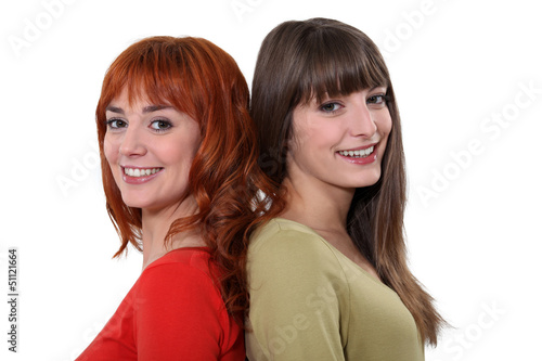 Photo: Friends standing back to back Friends standing back to back