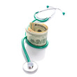 Doctor stethoscope with cash in dollars over white