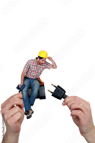 Photo: Electrician sitting on a plug Electrician sitting on a plug
