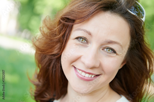 Photo: Smiling adult woman at spring outdoors Smiling adult woman at spring outdoors