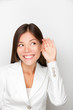 Business woman listening with hand to ear concept