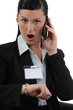 Shocked businesswoman talking on her cellphone
