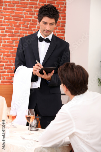 Photo: a waiter working at restaurant a waiter working at restaurant