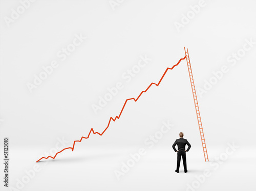 Photo: man looking at the growth of his business man looking at the growth of his business