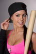 Pretty Female Baseball Lover Adjusts Hat Holding Wooden Bat