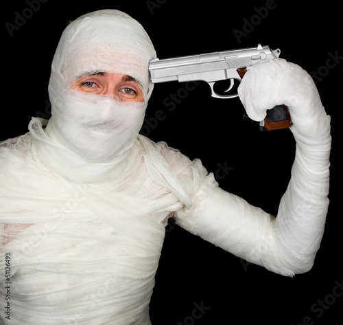 Photo: Completely bandaged man with gun - suicide Completely bandaged man with gun - suicide