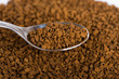 Spoon of coffee at coffe background