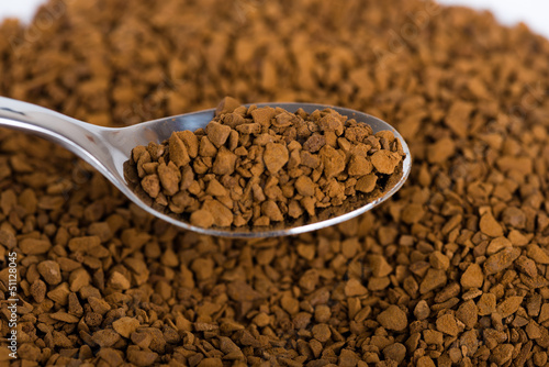 Photo: Spoon of coffee at coffe background Spoon of coffee at coffe background