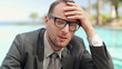Young tired, sad businessman resting by the pool, steadicam shot