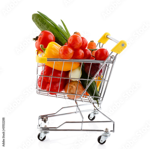 Photo: Shopping trolley full of vegetables on white background Shopping trolley full of vegetables on white background