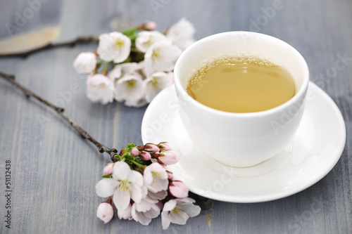 Photo: Cup of green tea and japanese cherry blossom Cup of green tea and japanese cherry blossom