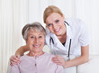 Portrait Of Doctor And Patient Sitting On Couch