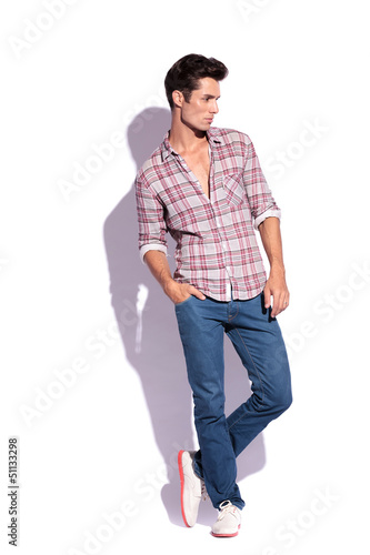 Photo: man with legs crossed looks away man with legs crossed looks away
