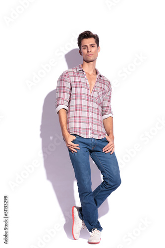 Photo: serious man stands with legs crossed serious man stands with legs crossed