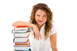 Young woman behind pile of books isolated on white background