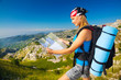 Woman on the mountain watching in map